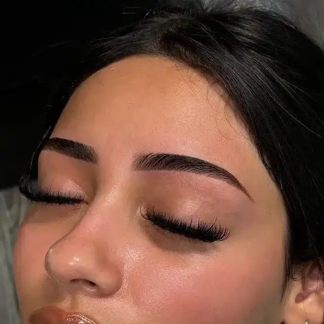 Woman with freshly done eyebrow threading and eyelash extensions.